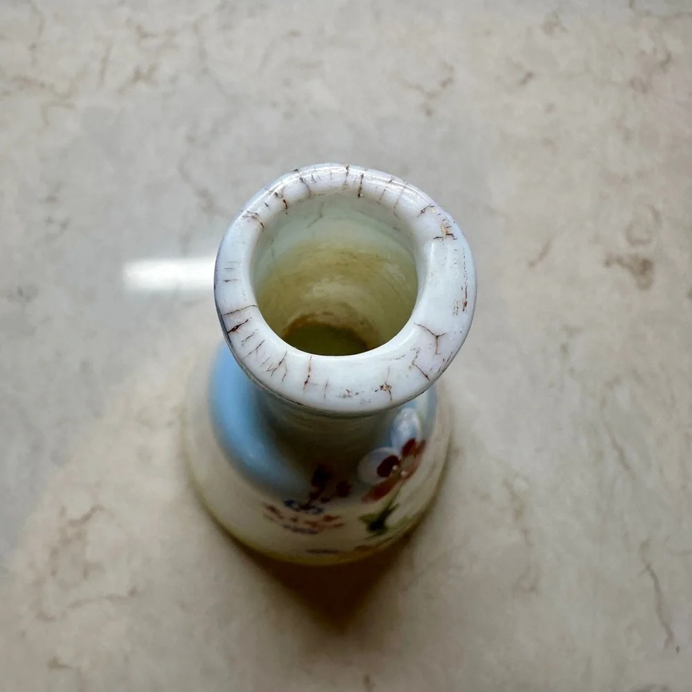 ANTIQUE BARBER SHOP BOTTLE WITH ATTRACTIVE CHERUB PICTURED ON FRONT SIDE.